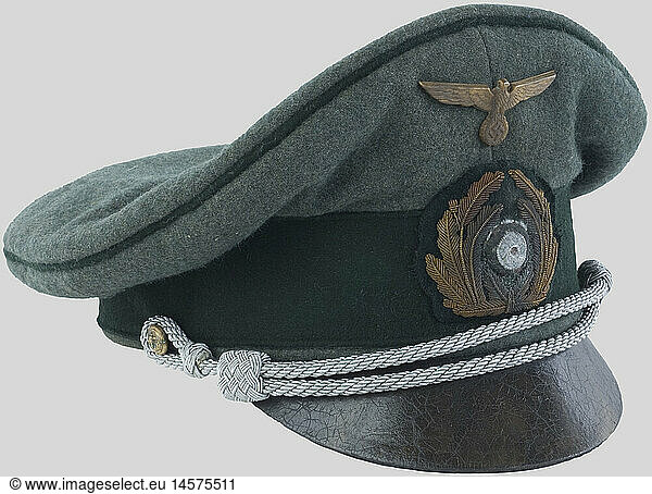 A German coastal artillery officer's cap.  Green cloth  dark green band  dark green piping  metallic eagle with embroidered oakleaves and cockade (lightly pitted). Silver twisted cord chinstrap  leather visor  blue silk inner lining with mica and tailor marking 'Danfoss DRP Berlin'.  historic  historical  1930s  1930s  20th century  navy  naval forces  military  militaria  branch of service  branches of service  armed forces  armed service  object  objects  stills  clipping  clippings  cut out  cut-out  cut-outs  uniform  uniforms  piece of clothing  clothes  outfit  outfits  helmet  helmets  cap  caps  headpiece  headpieces