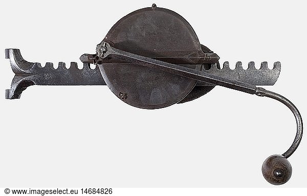 A German heavy crossbow cranequin  late 16th century Circular gear-box with a cord loop on the back. Curved winding bar with modest cut decoration and a wooden handle. Heavy clawed ratchet bar marked 'HM'/Crossbow on a coat of arms shield. Length 44 cm. historic  historical  16th century  crossbow  crossbows  distance weapon  weapons  object  objects  clipping  cut out  cut-out  cut-outs