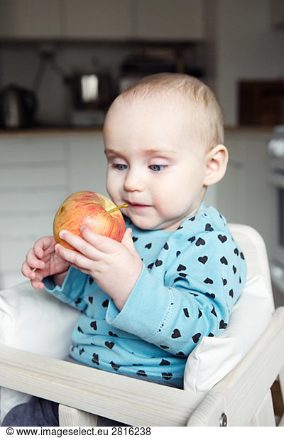 A girl having an apple Sweden.