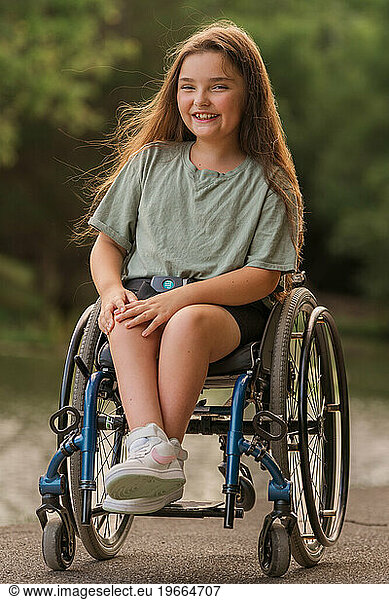 A girl in a wheelchair with her hair blowing in the wind