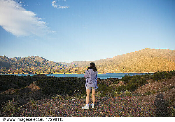 A girl photographs a magnificent landscape