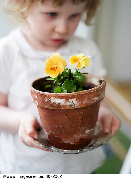 A girl potting plants Sweden.