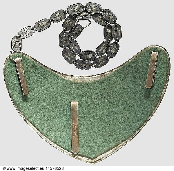 A gorget model 38 for SS standard bearers  Silvered shield with polished edges  the applied eagle and both corner rosettes patinated  the SS rune appliques kept silvered. Reverse two attachment hooks for the chain and a clamp hook with punch mark 'RZM M 1/128'. Light green felt liner. Patinated carrying chain  its alternating rows of SS runes and death's heads kept silvered. Of the utmost rareness  historic  historical  1930s  1930s  20th century  Waffen-SS  armed division of the SS  armed service  armed services  NS  National Socialism  Nazism  Third Reich  German Reich  Germany  military  militaria  utensil  piece of equipment  utensils  object  objects  stills  clipping  clippings  cut out  cut-out  cut-outs  fascism  fascistic  National Socialist  Nazi  Nazi period  insignia  symbols  symbol  emblem  emblems