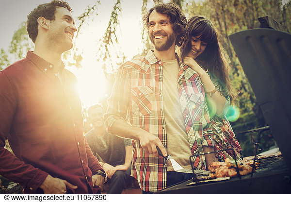 A group of friends at a summer evening barbeque.