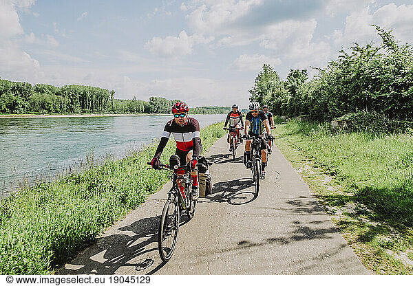 A group of friends cycling in the River Rin route  Germany