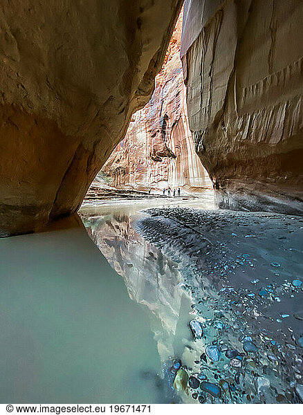 A group of hikers underneath Slide Rock Arch in Paria Canyon