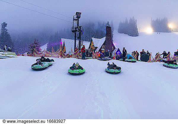 A group of tubers slide down the hill in Oregon.