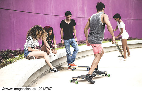 A group of young skateboarders in a skate park.