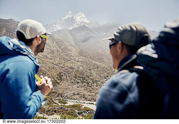 A guide and sherpa enjoying the view in Nepal while trekking in Nepal