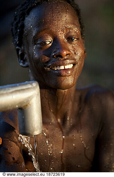 A Hamer boy washes himself at a well  Lower Omo Valley  Ethiopia.