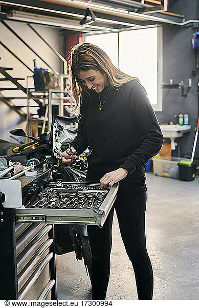 A happiness woman is working in a mechanic shop