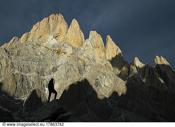 A hiker dwarfed against the massive peaks of the Fitzroy massif