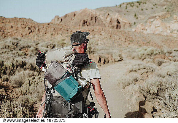 A hiker walking with his backpack in Guajara mountain  El Teide