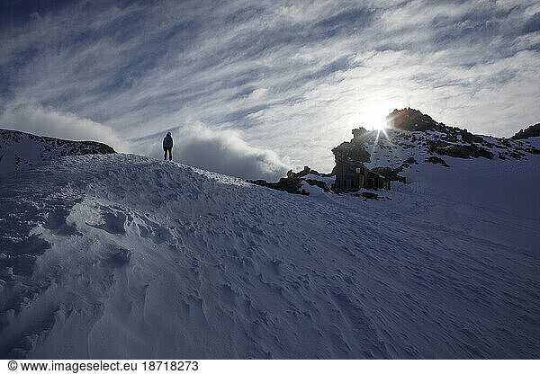 A Hiker Walks Along a Ridge in Mount Rainier's Camp Muir