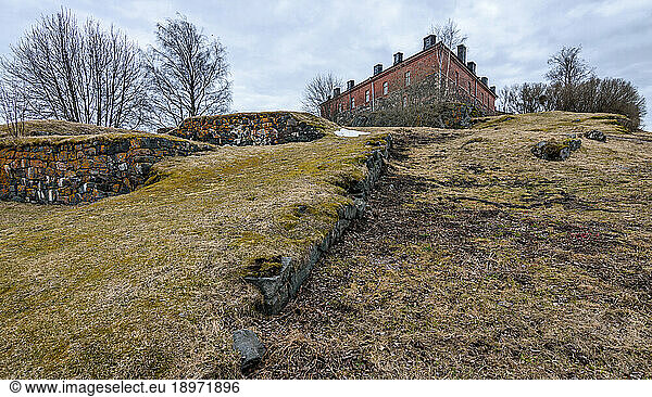 A historic site  a building and archaeological site  the island fortress of Suomenlinna  walls and ditches of the fort and a building.