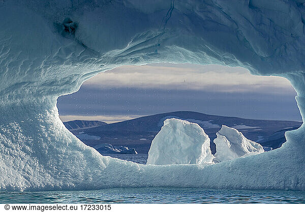 A hole in an iceberg in De Dodes Fjord (Fjord of the Dead)  Baffin Bay  Greenland  Polar Regions
