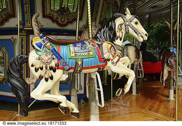 A horse-shaped carousel ride in the Boston Common  the oldest public park in the United States of America.; Boston Common  Boston  Massachusetts.