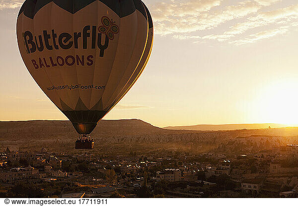 A Hot Air Balloon In Flight At Sunset; Cappadocia  Turkey