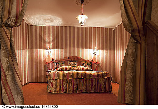 A hotel with old fashioned retro styled rooms  and rustic objects.