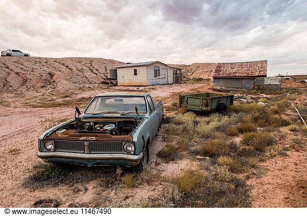 A house  spoil heap from the opal mining  and a wrecked ute. Andamooka  South Australia  Australia. (Photo by: Auscape/UIG)