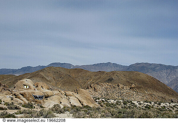 A huge granite boulder is graffitied to look like a monster in the Alabama Hills in the Eastern Sierra  CA.