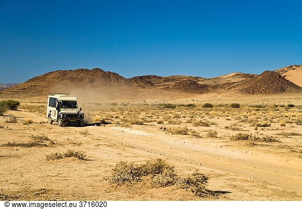 A landrover driving through the desert in Namibia  Africa