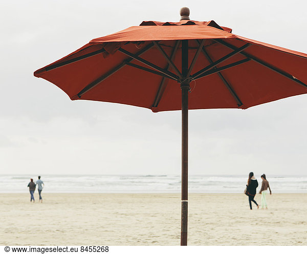 A large beach umbrella on the beach at Manzanita  on the Pacific Ocean in Oregon.