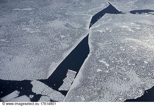 A large detached piece of sea ice breaks away from the main structure. Photographed out from the window of the Twin Otter aeroplane en route up to Centrum So? from Mestersvig.; Northeast Greenland   Greenland