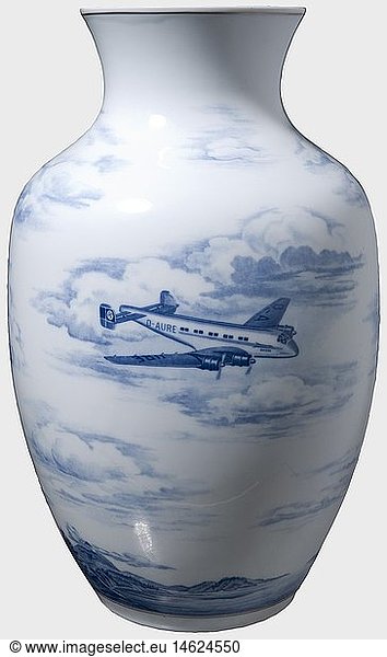 A large Meissen vase  a 1940 gift of the Junkers factory White porcelain with cobalt-blue decoration. A Ju 90 and a Ju 88 each on one side in front of surrounding clouds and mountains. Underglaze blue sword mark and the company logo 'Junkers 1940' on the bottom. Tiny crack in the base ring. Height 42 cm. historic  historical  1930s  20th century  Air Force  branch of service  branches of service  armed service  armed services  military  militaria  air forces  object  objects  stills  clipping  clippings  cut out  cut-out  cut-outs  vessel  vessels