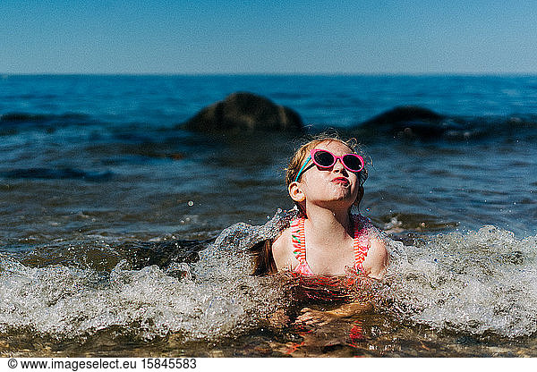 A little girl swims in the Long Island Sound.