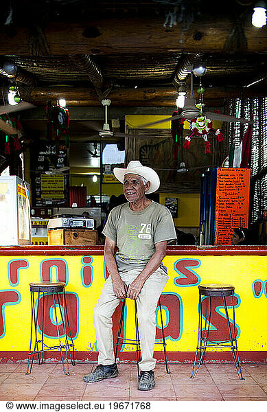 A local man sits at a restaurant bar in Todos Santos  Mexico.