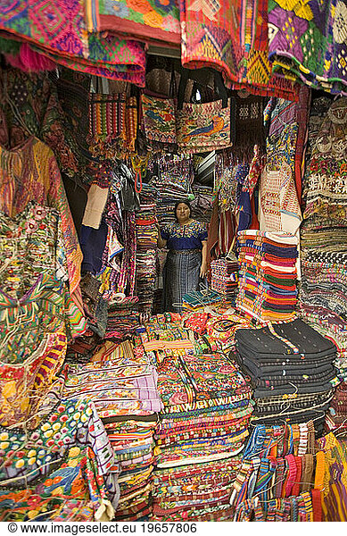 A local vendor sells her wares of authentic and colorful textiles in shopping both  Antigua  Guatemala