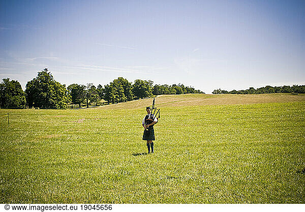 A lone girl wearing traditional Celtic clothing practices with her bagpipe at the 2009 Celtic Festival in Leesburg  VA.