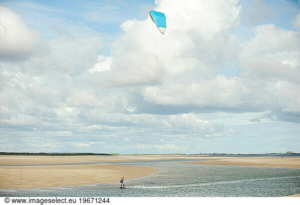 A lone kite surfer rides the windy North Sea.