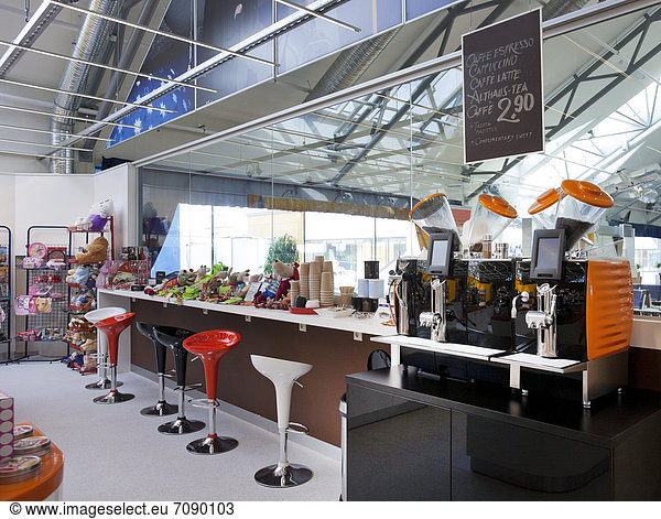 A long bar counter and coffee shop at Tallinn airport.