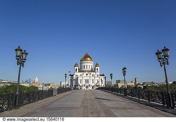A long walkway leading to the Cathedral of Christ the Saviour with gold onion domes against a bright blue sky  Russian Orthodox Church (Moscow Patriarchate); Moscow  Russia