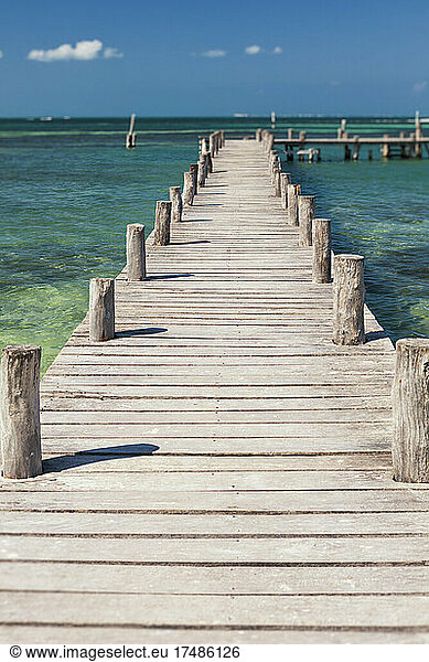 A long wooden jetty or pier  stretching out over the water