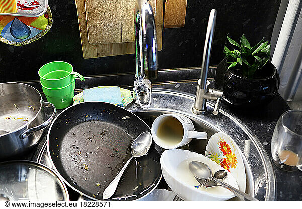 A lot of dirty dishes in the sink in the kitchen
