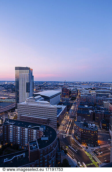 A magenta filled sky spreads across the cityscape in Boston  MA.