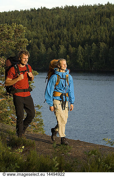 A man and a woman walking by a lake  Sweden.
