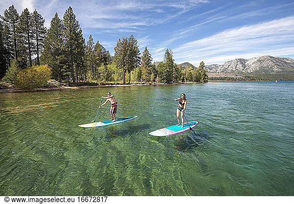 A man and woman stand up paddle boarding on Lake Tahoe  CA