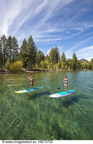 A man and woman stand up paddle boarding on Lake Tahoe  CA