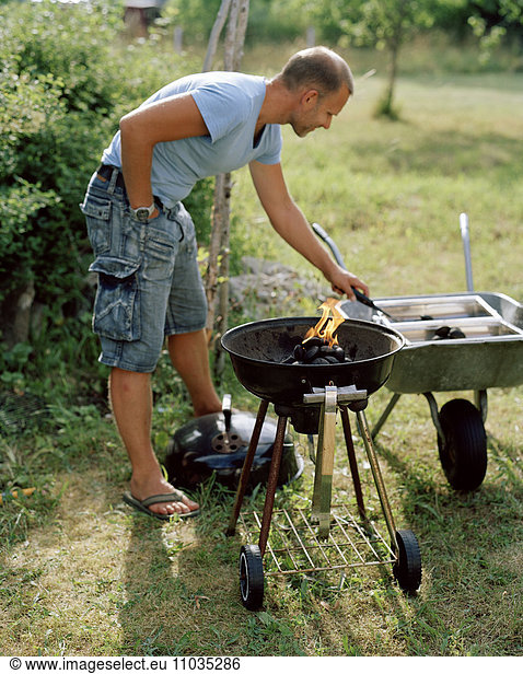 A man barbecuing.