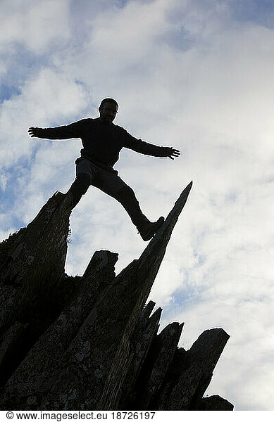 A man climbing on Fleetwith Pike  Lake District  UK.