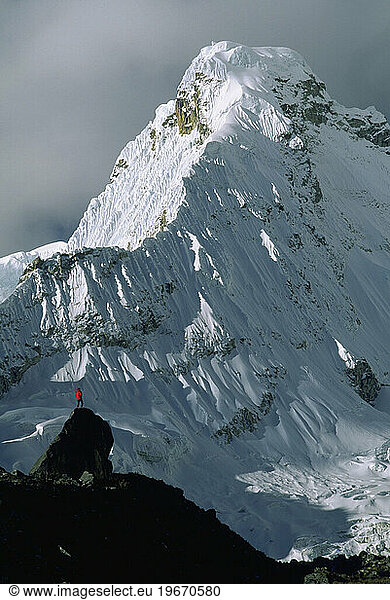 A man contemplates the mountains.