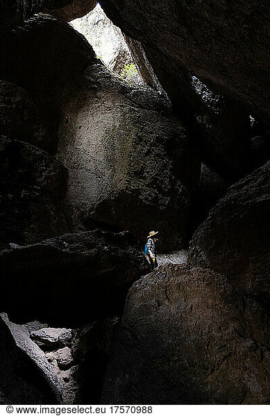 A man hikes through caves in California