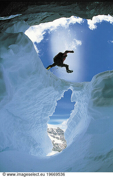 A man jumps over a Crevasse.