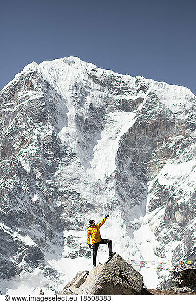 A man poses under the mountains on the Everest Base Camp Trek.