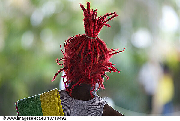 A man sports bright red dreadlocks in Port-au-Prince  Haiti.