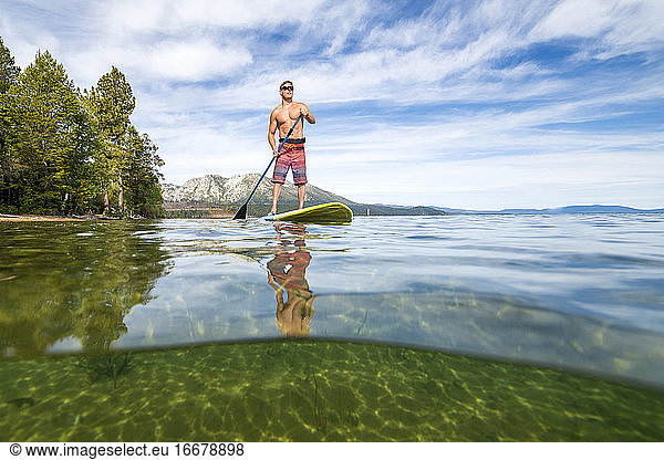 A man stand up paddle boarding on Lake Tahoe  CA